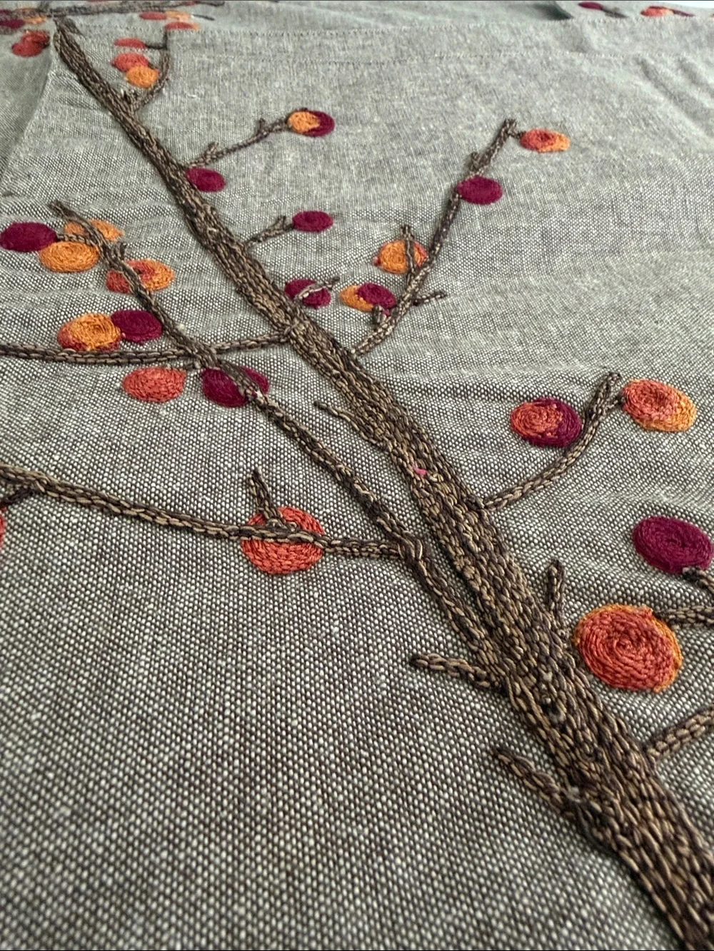 Crate&Barrel Embroidered Placemats with Shades of oranges and reds.